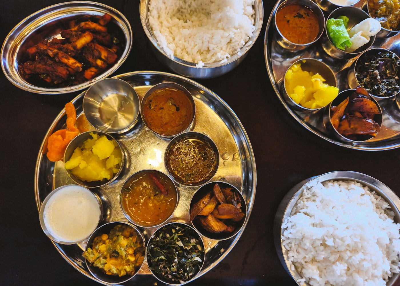 A mixed Indian thali with multiple dishes identified